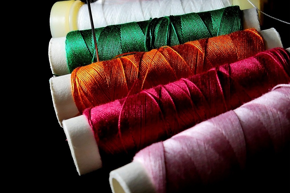 assorted different colors of sewing thread